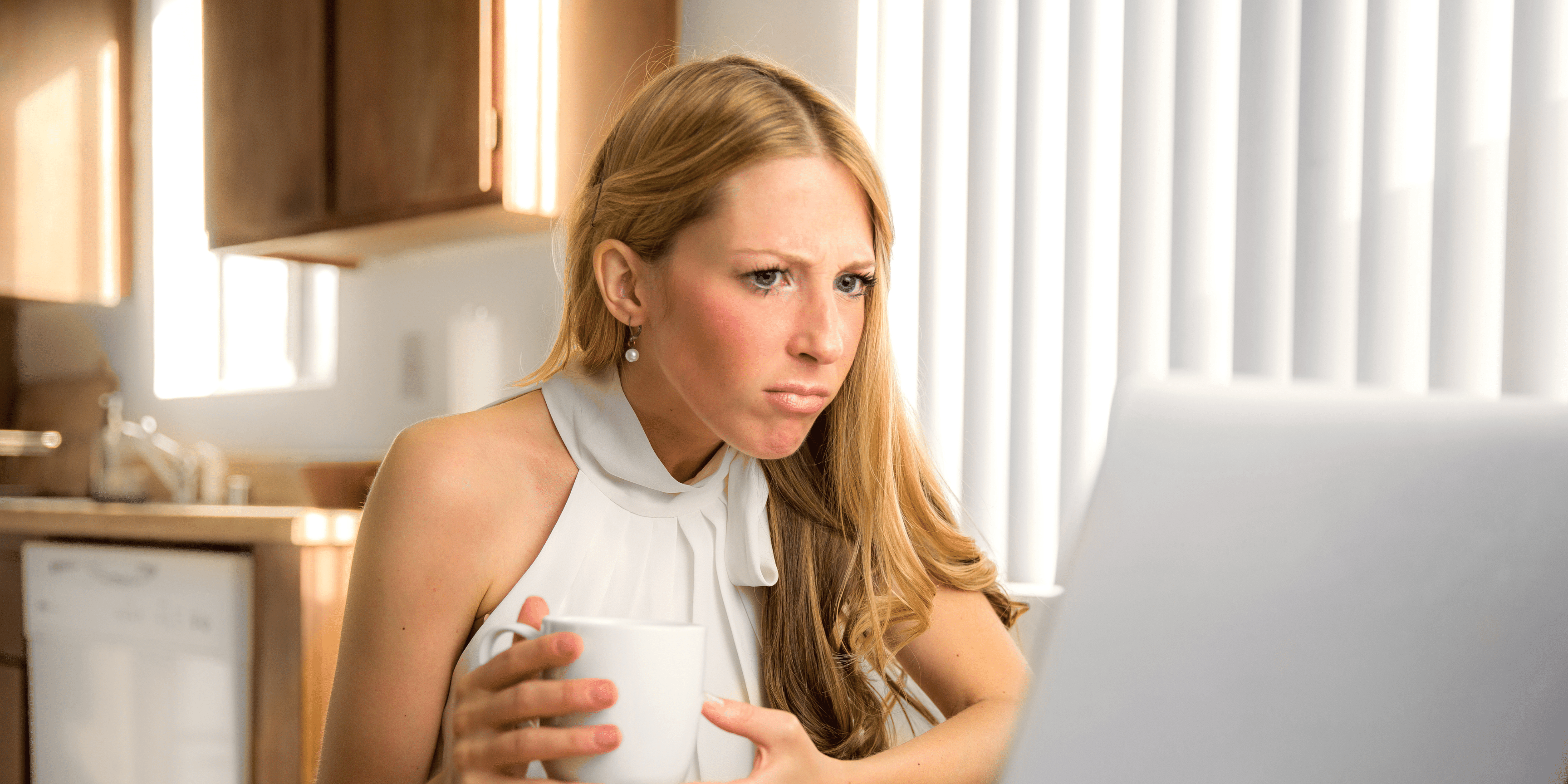 perplexed young woman looking at computer