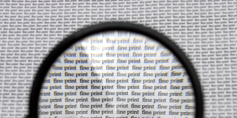 fine print under magnifying glass