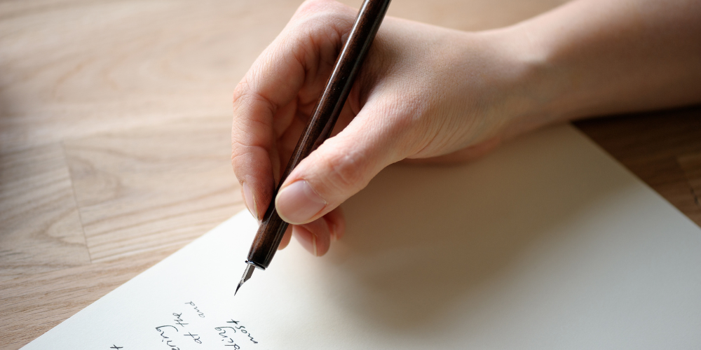 female hand writing a letter