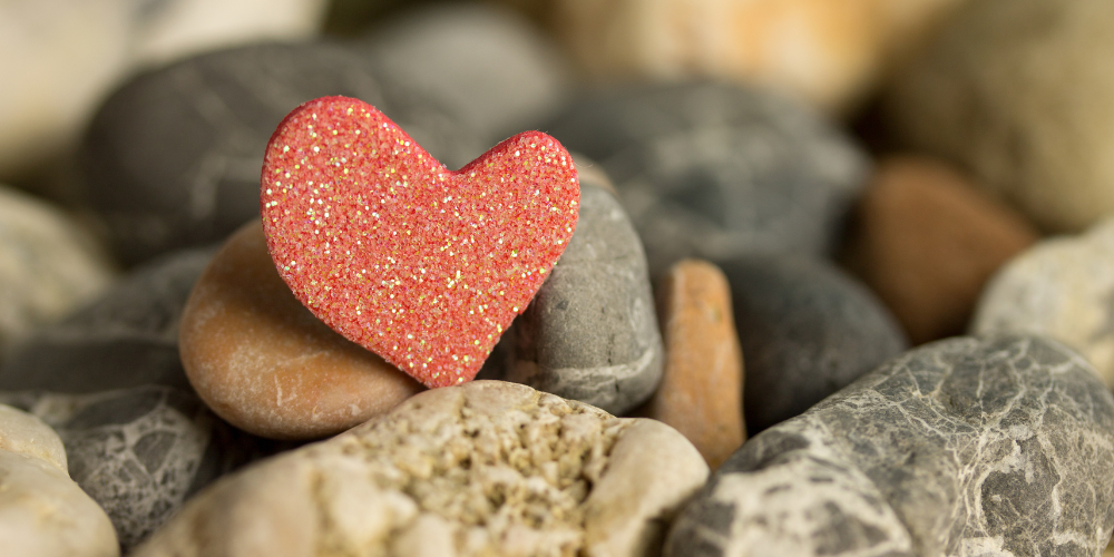 red heart-shaped stone among pile of rocks